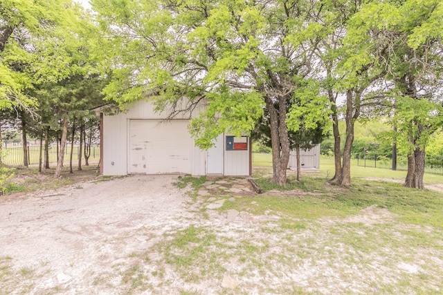 detached garage featuring fence