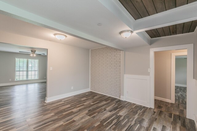 empty room with dark wood-type flooring, a ceiling fan, and baseboards