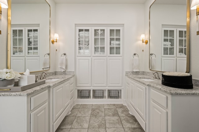 full bathroom featuring two vanities and a sink