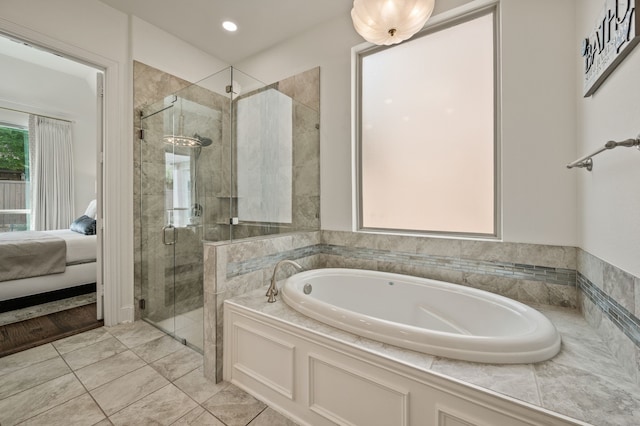 ensuite bathroom with a bath, a shower stall, ensuite bath, and recessed lighting