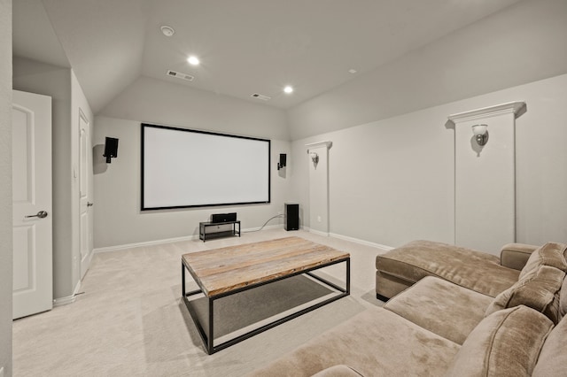cinema with light carpet, vaulted ceiling, visible vents, and baseboards