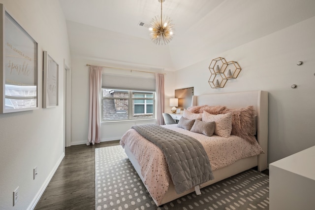 bedroom with wood finished floors, visible vents, baseboards, and an inviting chandelier