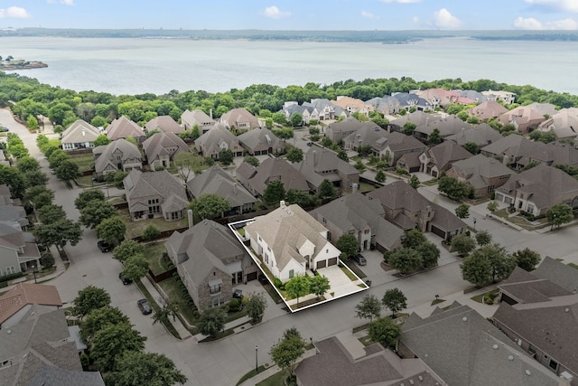 drone / aerial view with a residential view and a water view