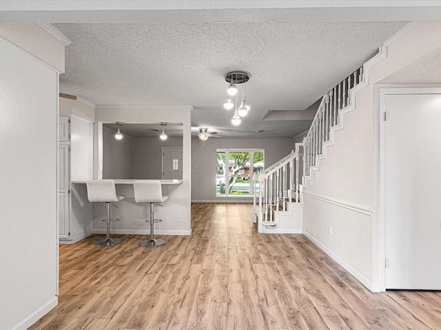 13514 Onyx Ln, Farmers Branch, TX 75234 - foyer with baseboards, wood finished floors, a textured ceiling, and stairs