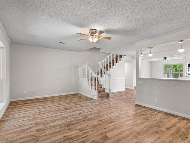 13514 Onyx Ln, Farmers Branch, TX 75234 - unfurnished living room with a ceiling fan, wood finished floors, stairs, a textured ceiling, and visible vents