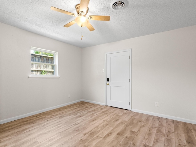13514 Onyx Ln, Farmers Branch, TX 75234 - unfurnished room with a ceiling fan, a textured ceiling, light wood-style flooring, baseboards, and visible vents