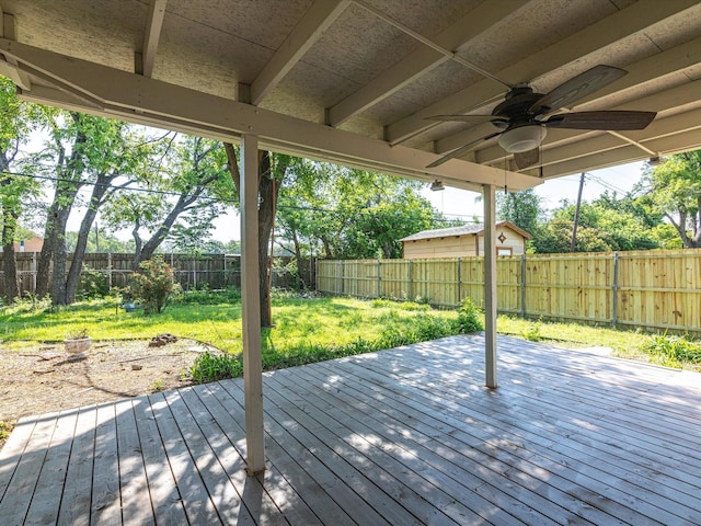 13514 Onyx Ln, Farmers Branch, TX 75234 - wooden terrace with a fenced backyard, ceiling fan, and a lawn