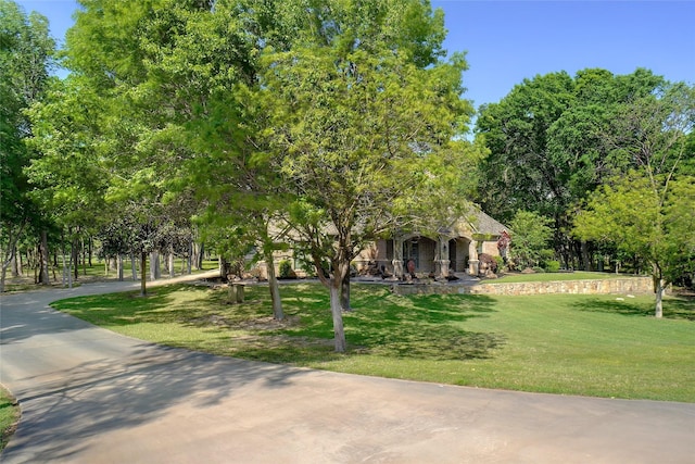 obstructed view of property featuring a front lawn and covered porch
