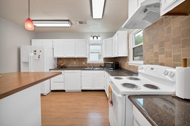 kitchen featuring visible vents, dark countertops, under cabinet range hood, white appliances, and white cabinetry