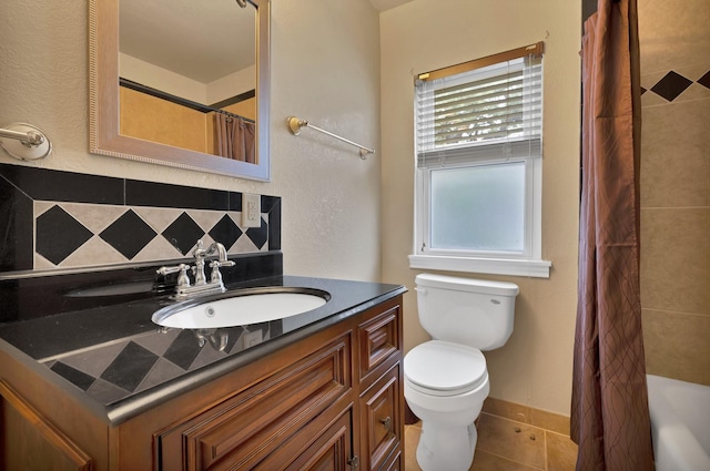 bathroom with vanity, tile patterned flooring, backsplash, and toilet