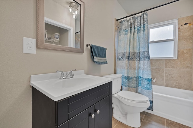bathroom featuring vanity, tile patterned floors, shower / bath combo with shower curtain, and toilet