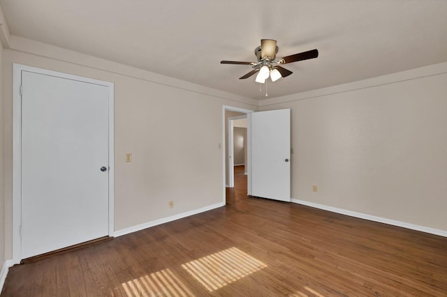unfurnished bedroom featuring a ceiling fan, baseboards, and wood finished floors