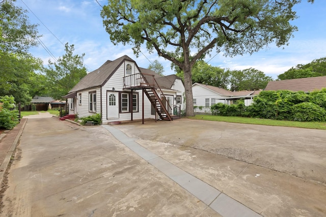 view of front of house with concrete driveway and stairway