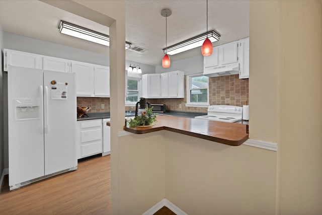 kitchen featuring white appliances, white cabinetry, backsplash, under cabinet range hood, and visible vents