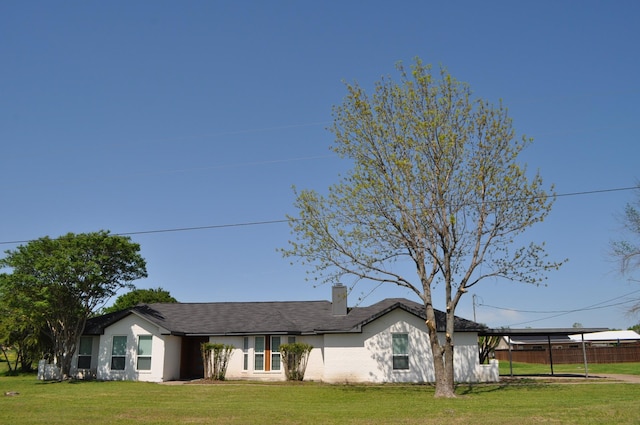 single story home with a chimney, a front yard, and fence