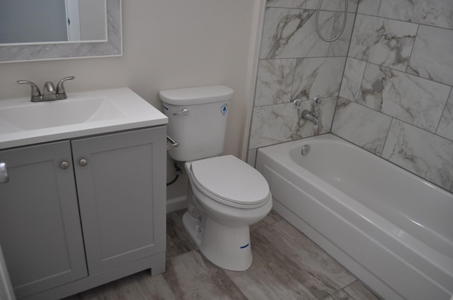 full bathroom with wood finished floors, toilet, vanity, and washtub / shower combination