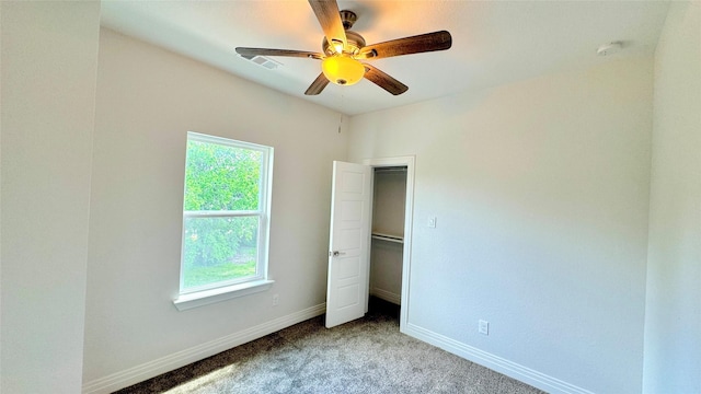 unfurnished bedroom with ceiling fan, carpet floors, visible vents, and baseboards