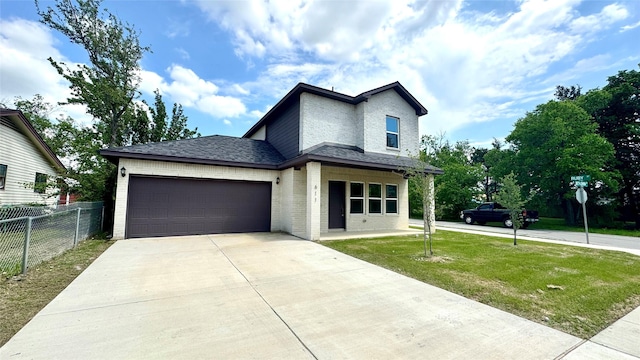 view of front of house with driveway, fence, a garage, brick siding, and a front yard