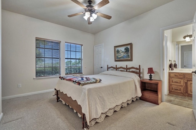 bedroom featuring baseboards, a ceiling fan, light colored carpet, and connected bathroom