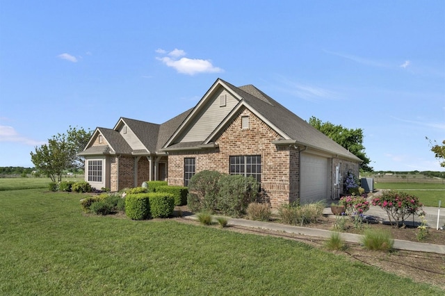 view of front of home featuring a garage, brick siding, a front yard, and roof with shingles