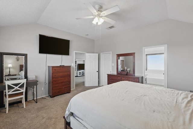 7308 Circle Dr, North Richland Hills, TX 76180 - bedroom featuring vaulted ceiling, light carpet, ceiling fan, connected bathroom, and a textured ceiling