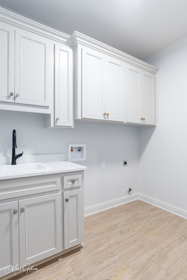831 Walstonburg Ln, Benton, LA 71006 - laundry area with hookup for a washing machine, cabinet space, light wood-type flooring, and electric dryer hookup