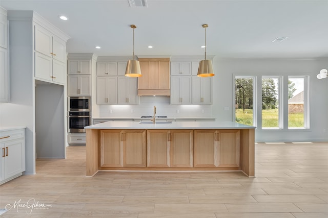 831 Walstonburg Ln, Benton, LA 71006 - kitchen with appliances with stainless steel finishes, light countertops, backsplash, recessed lighting, and a center island with sink
