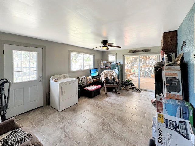 interior space featuring stone finish flooring, ceiling fan, and washer / clothes dryer