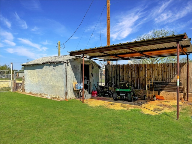 view of outbuilding with fence, an outdoor structure, and a gate