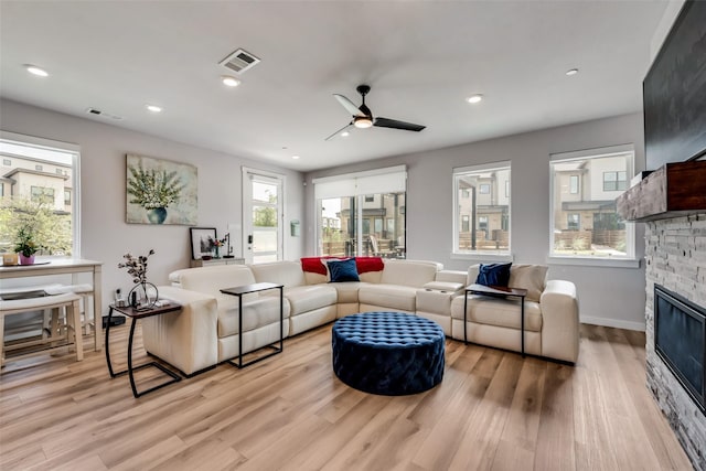 720 Bandera Ct, Prosper, TX 75078 - living room with a fireplace, visible vents, light wood finished floors, and ceiling fan