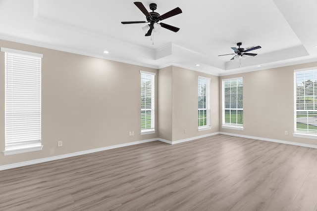 1991 Sunset Trl, Mckinney, TX 75071 - spare room with a raised ceiling, light wood-style floors, a ceiling fan, and ornamental molding