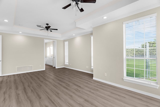 1991 Sunset Trl, Mckinney, TX 75071 - unfurnished living room with a ceiling fan, wood finished floors, a tray ceiling, ornamental molding, and visible vents