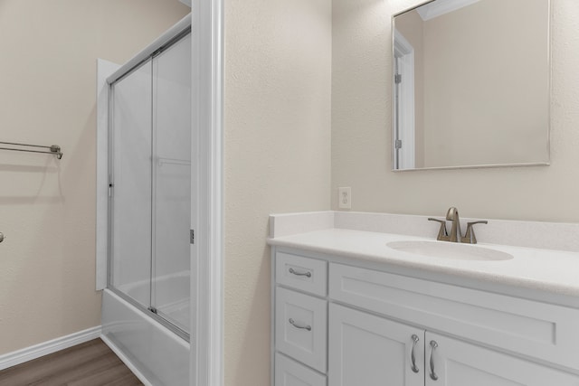 1991 Sunset Trl, Mckinney, TX 75071 - full bathroom with baseboards, wood finished floors, vanity, and enclosed tub / shower combo