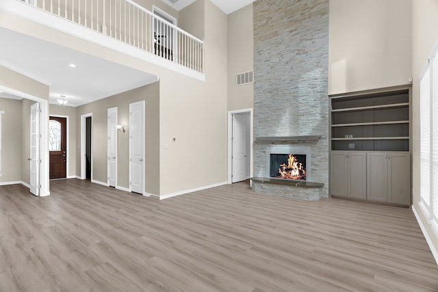 1991 Sunset Trl, Mckinney, TX 75071 - unfurnished living room featuring wood finished floors, visible vents, baseboards, and a high ceiling