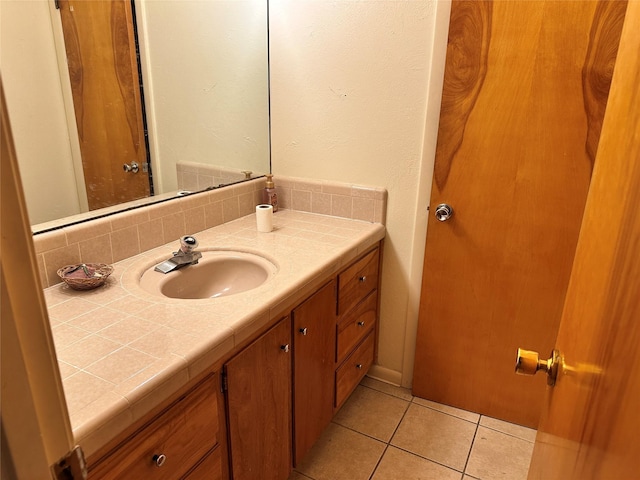 bathroom with tile patterned floors and vanity