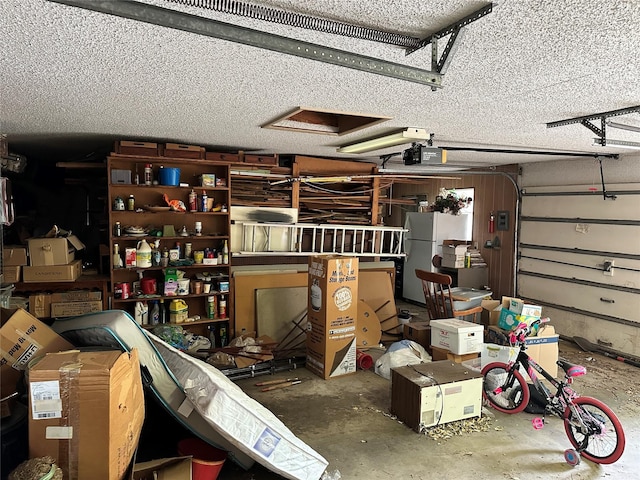 garage with freestanding refrigerator and a garage door opener