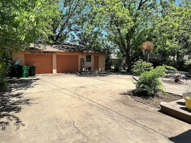 exterior space with driveway, an outbuilding, and a garage