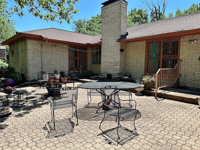 view of patio / terrace featuring outdoor dining space and an outdoor fire pit