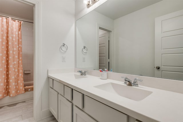 full bathroom with shower / bath combination with curtain, a sink, and double vanity