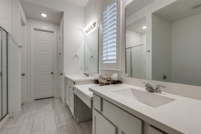 full bathroom featuring recessed lighting, a stall shower, and a sink
