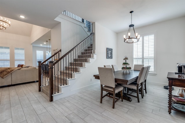 dining space with stairs, a chandelier, light wood-type flooring, baseboards, and recessed lighting