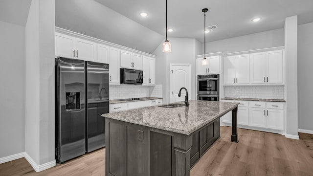 kitchen with backsplash, white cabinetry, a sink, and black appliances