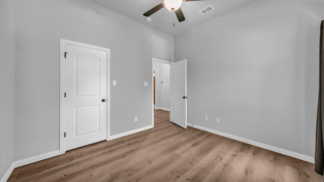 unfurnished bedroom with wood finished floors, visible vents, and baseboards