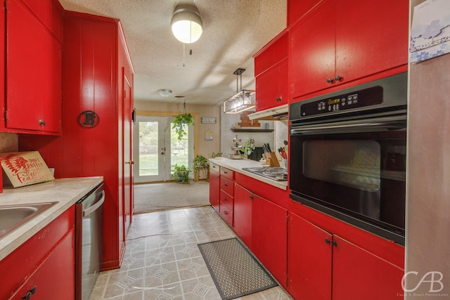 kitchen featuring red cabinets, appliances with stainless steel finishes, a textured ceiling, and light countertops