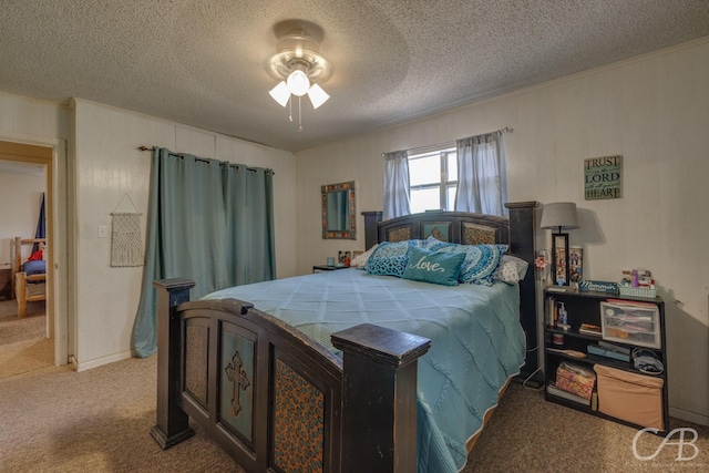 bedroom with ceiling fan, crown molding, carpet flooring, and a textured ceiling