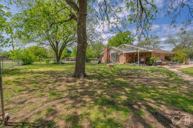 view of yard with fence and a patio