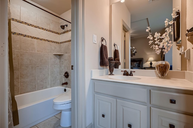 bathroom with tile patterned floors, toilet, ensuite bathroom, shower / tub combo with curtain, and vanity