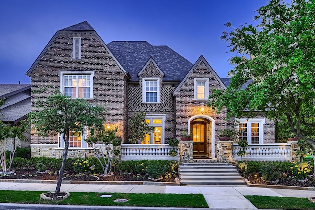 tudor home with stone siding and brick siding