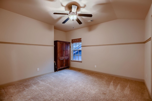 empty room featuring baseboards, visible vents, light colored carpet, and ceiling fan