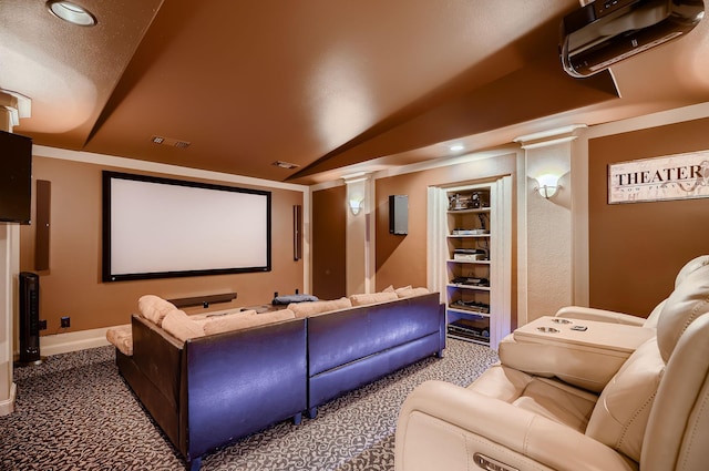 carpeted home theater with vaulted ceiling, visible vents, recessed lighting, and ornate columns